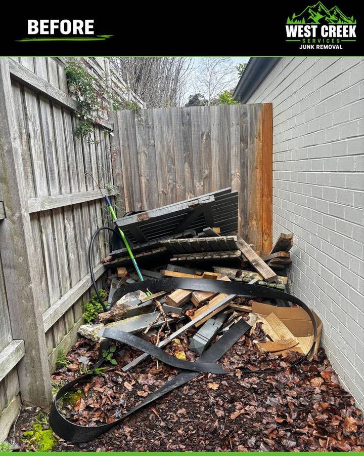 Before: Pile of old timber, decking and edging in a side yard