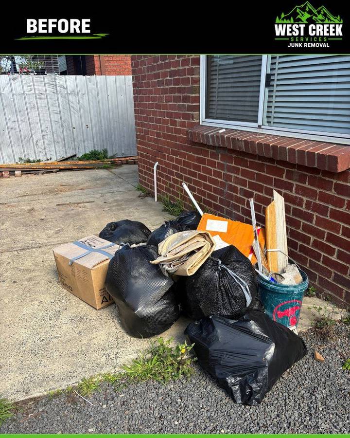 Before: Bags, boxes and building scraps beside a house