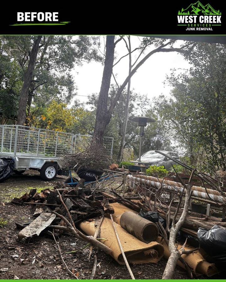 Before: Branches, timber and rolls of carpet by a trailer